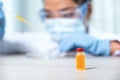 Vaccine stand in front of doctor the pipette and drop the yellow chemical liquid into a petri dish for research and analysis for