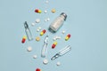 Vaccine and syringe, assorted pharmaceutical medicine pills, tablets and capsules on blue background. Healthcare and Royalty Free Stock Photo