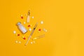 Vaccine and syringe, assorted pharmaceutical medicine pills, tablets and capsules on yellow background. Healthcare and