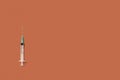 Vaccine syringe isolated on orange background. copyspace Royalty Free Stock Photo