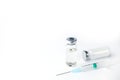 Vaccine vial, drug bottle and syringe injection on a white background. Vaccination, immunization, treatment to Covid-19. Top view