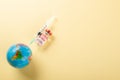 Vaccine vials bottles, syringes for vaccination against coronavirus and globe