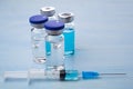 Vaccines and syringes on blue wooden table Royalty Free Stock Photo