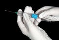 Vacutainer blood collection system in the hands of a medic in latex gloves on a black background Royalty Free Stock Photo
