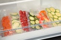 Vacuum bags with different vegetables in fridge. Food storage