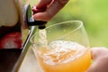 Vacuum boxed apple juice being poured into a glass