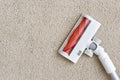 Vacuum cleaner brush part on beige carpet with copy space Royalty Free Stock Photo