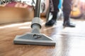 Vacuum cleaner brush on wooden floor closeup