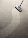 Vacuum cleaner on a carpet with a clean strip for copy space Royalty Free Stock Photo