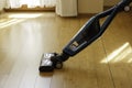 Vacuum cleaner cleaning bamboo flooring in a room Royalty Free Stock Photo