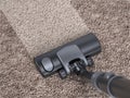 Vacuum cleaner cleans dirty carpet - house cleaning concept Royalty Free Stock Photo