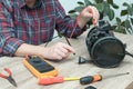 Vacuum cleaner disassembled for repair malfunctioning on work table. Small business. Serviceman is repairing modern vacuum cleaner