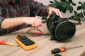 Vacuum cleaner disassembled for repair malfunctioning on work table. Small business. Serviceman is repairing modern vacuum cleaner