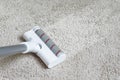 Vacuum cleaner head on dirty carpet with clean strip. Housework with using hoover. Turbo brush of modern vacuum cleaner close up Royalty Free Stock Photo