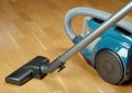Vacuum cleaner on a oak parquet Royalty Free Stock Photo