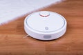 Vacuum cleaner robot on laminate wood floor Royalty Free Stock Photo