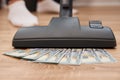 Vacuum cleaner suck usd dollar banknotes. Launder money concept Royalty Free Stock Photo