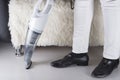 Vacuum cleaner vacuuming white wooden floor and cropped view of maid or housewife legs near sofa. Cleaning home Royalty Free Stock Photo