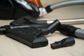 Vacuum cleaner on the wooden floor. Black vacuum cleaner brush closeup Royalty Free Stock Photo