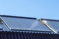 Vacuum solar water heating system on the house roof. Royalty Free Stock Photo