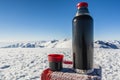 Vacuum flask of hot tea on a table with a boundary marker in the Royalty Free Stock Photo