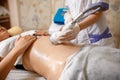 Vacuum massage device. Anti cellulite body correction treatment. Loss weight apparatus. Woman and doctor at medicine Royalty Free Stock Photo