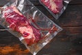 Vacuum packed Chuck roll  beef steak on dark old wooden background, close up top view Royalty Free Stock Photo