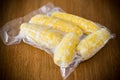 Vacuum-packed fresh corn on a wooden table Royalty Free Stock Photo