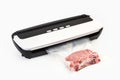 Vacuum packing machine and meat in a plastic bag Royalty Free Stock Photo