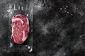 Vacuum plastic pack with fresh beef steak, on black dark stone table background, top view flat lay, with copy space for text Royalty Free Stock Photo