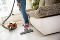 Vacuuming floor with vacuum cleaner