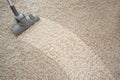 Vacuuming rough carpet with vacuum cleaner Royalty Free Stock Photo
