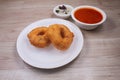 Vada / Medu Vadai with Sambar - Popular South Indian snack served on sheet steel, selective focus