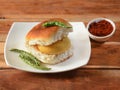 Vada Pav, Mumbai Famous vada paav is an indian burger. Potato patty is deep fried and stuffed inside a paav or bun like burger, Royalty Free Stock Photo