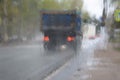 The vague image of the truck through the glass which is filled in with a rain