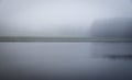 Vague misty and mysterious landscape with channel and grass river bank