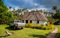 Vailala, Wallis and Futuna. A typical rural cottage in Wallis resembles traditional thatched roof Polynesian fale. Pickup car.