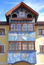 A colorful house facade Sarteur House with paintings and a musical clock on the top in Selva