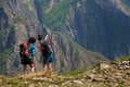 VAL GRANDE, ITALY - Apr 25, 2018: Female hikers pointing and looking at a beautiful view from a mountain top Royalty Free Stock Photo
