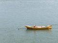 A fisherman fixes his boat at the mouth of the Valdivia River. Valdivia, River Region, southern Chile