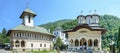 Tourists visit the old Lainici Monastery on a summer`s day, detail from the courtyard with exterior paintings