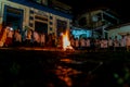 Catholic priest is celebrating night mass around the holy bonfire on hallelujah saturday night. Holy week in Valenca, Bahia Royalty Free Stock Photo