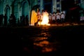 Catholic priest is celebrating night mass around the holy bonfire on hallelujah saturday night. Holy week in Valenca, Bahia Royalty Free Stock Photo