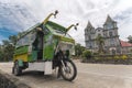Valencia, Bohol, Philippines - A motorela, a variant of a tricycle, is parked in front of The Parish of the Santo NiÃÂ±o