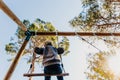 Valencia, Spain - April 4, 2019: Child swinging fun in a natural park seen from below Royalty Free Stock Photo
