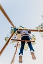 Valencia, Spain - April 4, 2019: Child swinging fun in a natural park seen from below Royalty Free Stock Photo