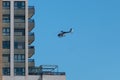 A National Police helicopter model Eurocopter EC-135 from Airbus company, hovers over residential