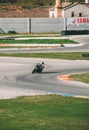 VALENCIA, SPAIN - Dec 06, 2020: White Suit Pilot Biker Turning a Circuit Curve on his Motorcycle (Vertical Shot Royalty Free Stock Photo