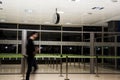 Valencia, Spain - December 13, 2019 - Defocused people walking inside the airport. Clock on the ceiling of the room Royalty Free Stock Photo