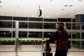 Valencia, Spain - December 13, 2019 - Defocused people walking inside the airport. Clock on the ceiling of the room